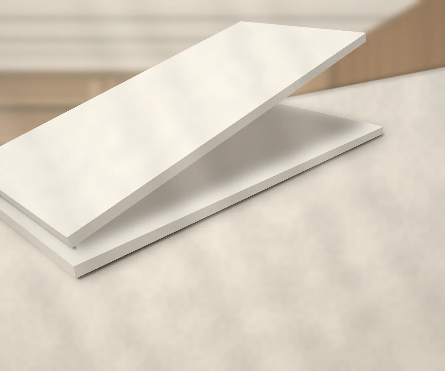 Two bright white DUROMAK sheets on a stone worktop, the top sheet raised to show its edge